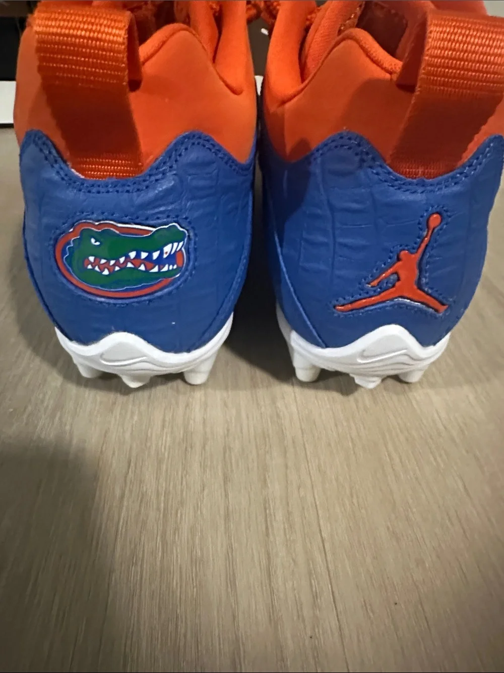 Custom Florida Air Jordan Cleats in Orange and Blue.
